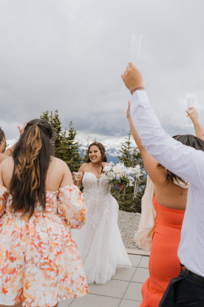 The bride gets a drink and cheers with her guests right after the wedding ceremony near Mt. Rainier National Park. 