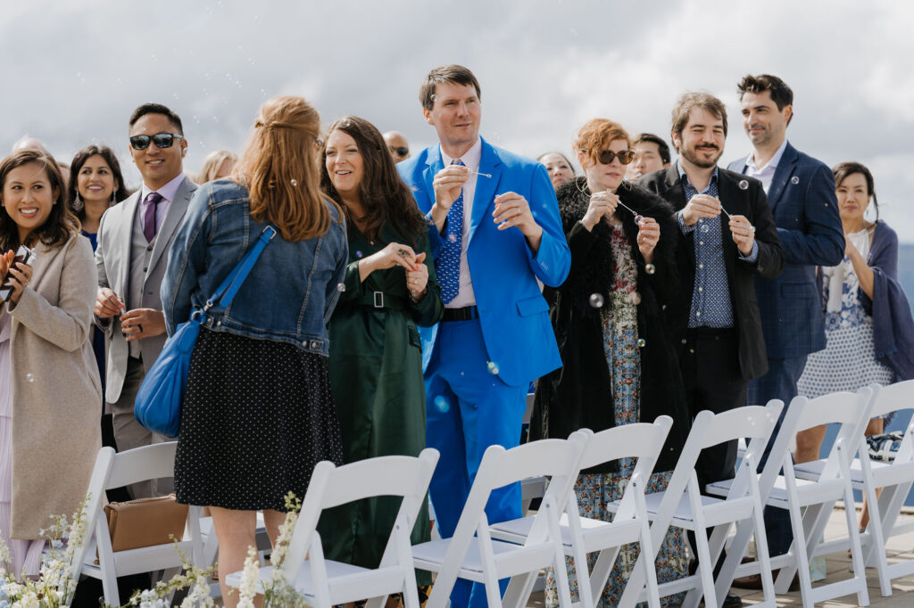 Wedding guests blow bubbles right after the wedding ceremony atop Crystal Mountain.