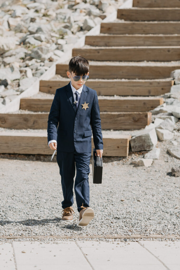 A ring bearer walking down the aisle at Crystal Mountain.