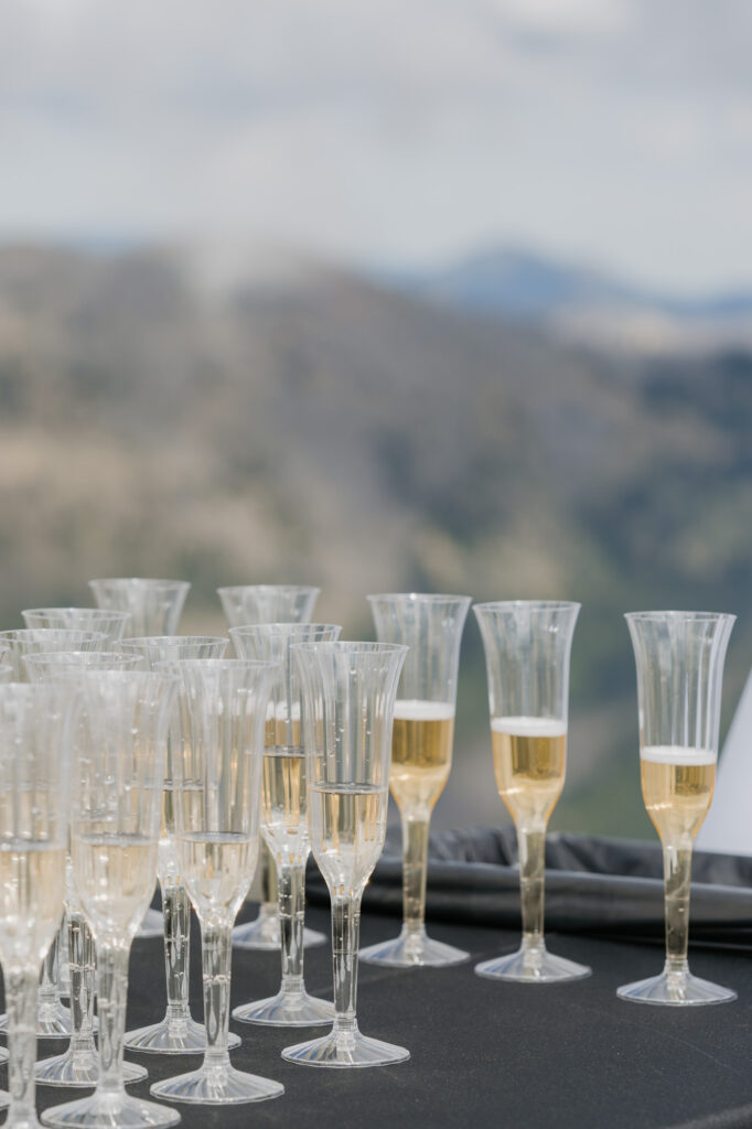 Champagne glasses sitting on the table with a view of Mt. Rainier National Park in the background. 