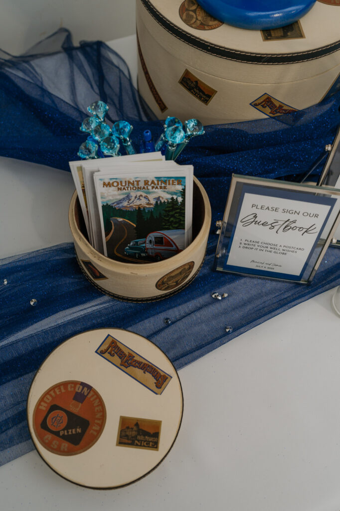A guestbook table with stickers of Mt. Rainier national park. 