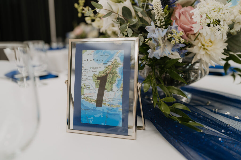 A wedding day table decorated with flowers and blue accents. 