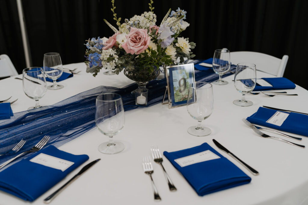 A wedding day table decorated with flowers and blue accents. 