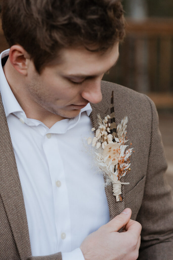 A groom fixes his boutonnière