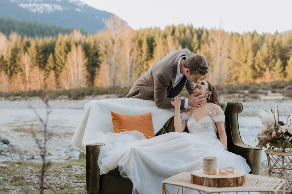 A bride and groom embracing each other in front of the river in Washington on their elopement day