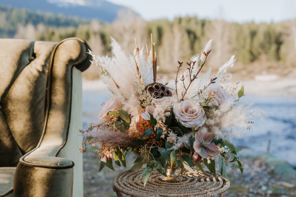 A floral arrangement for a Washington elopement with the river in the background.